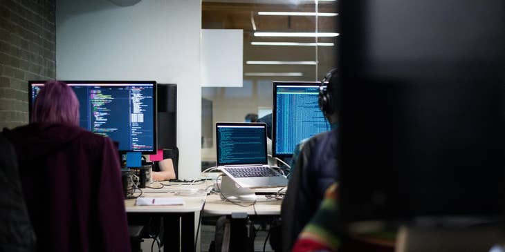 Enterprise Architects working on their respective workstations and integrating the programs used by their clients