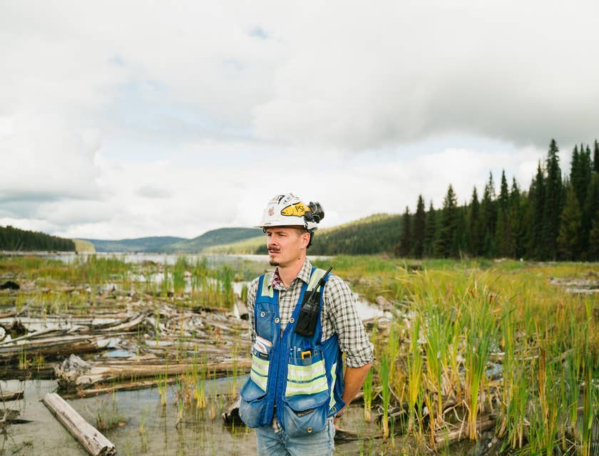An environmental engineer with a hard hat and vest working at an engineering site.