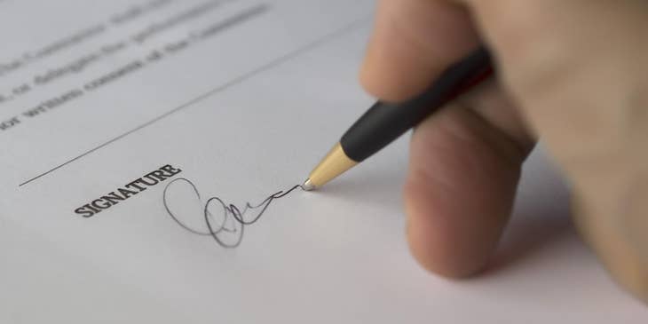 Person signing an equal opportunity employer statement.