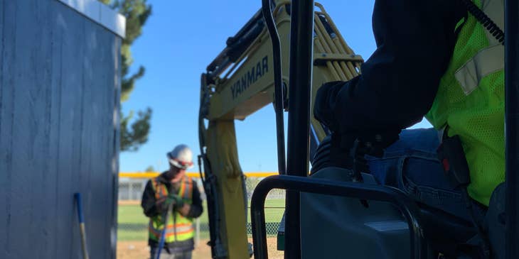 Equipment Operator ensures safety while operating an excavator.
