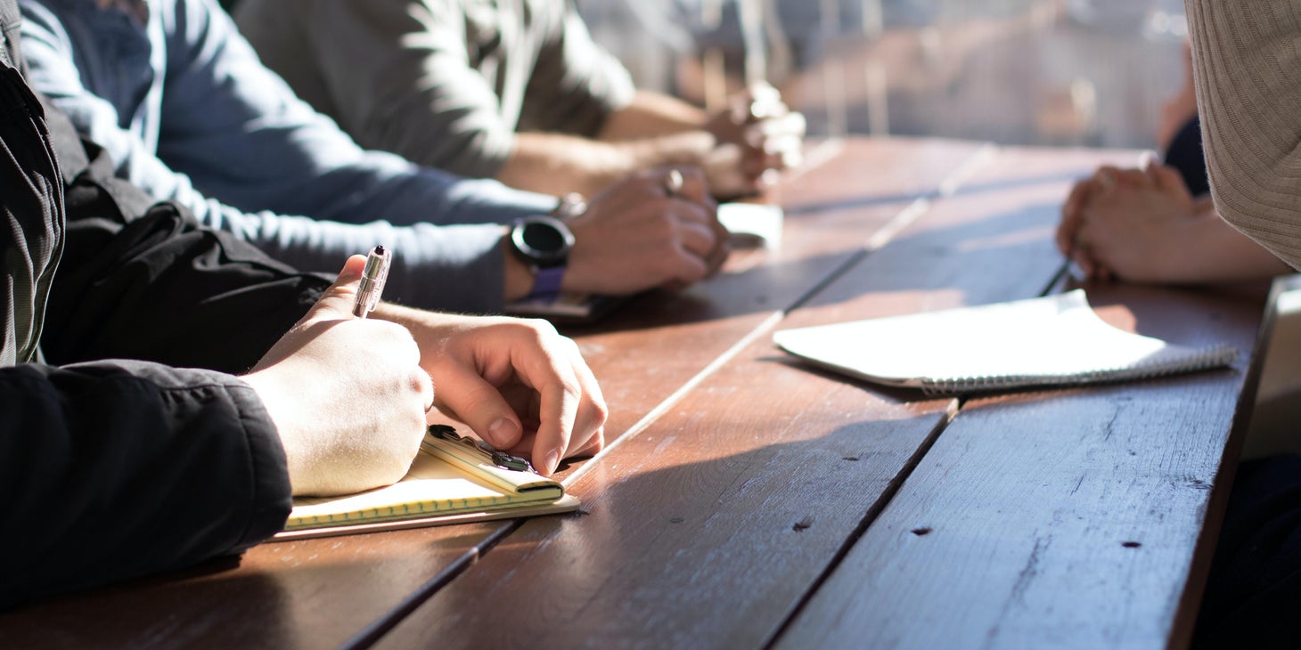 The event planner is conceptualizing theme ideas and planning budgets with his team.