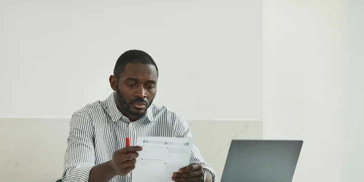 An examiner reviewing students' homework.