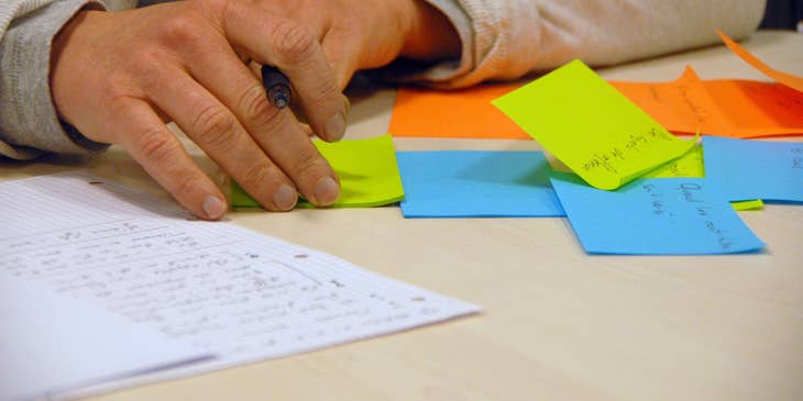 Executive Assistant writing reminders on post-it notes