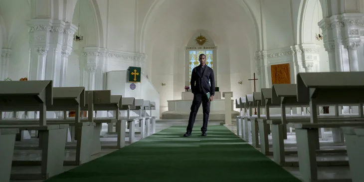 An executive pastor standing in the middle of a church.