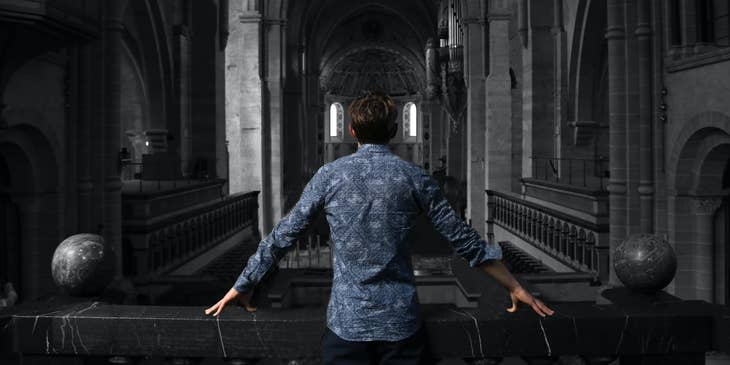 Executive Pastor standing inside the church checking its interiorhttps://unsplash.com/photos/FFd8nqZ_2S0