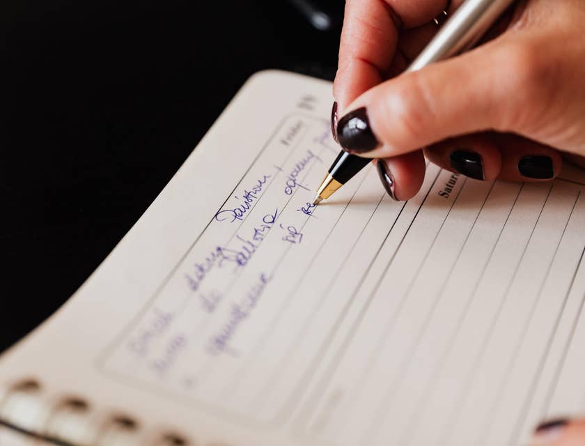Executive Secretary writing on a schedule book