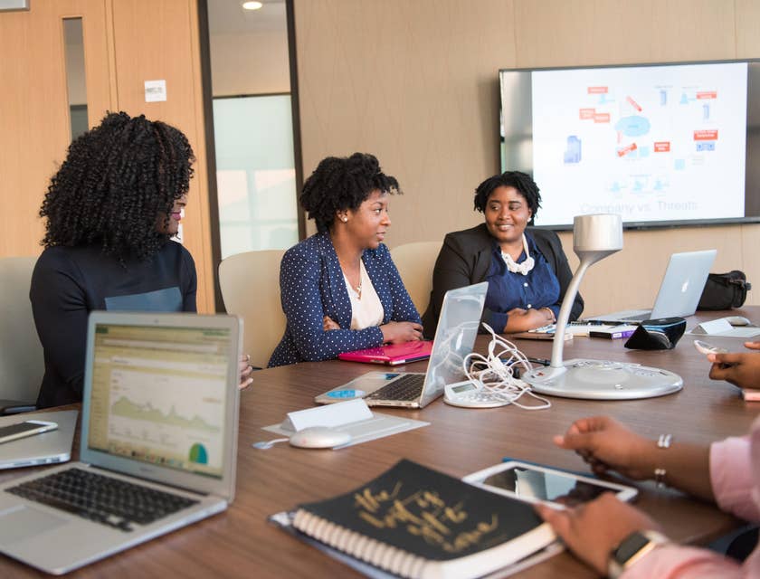 Female financial consultant sitting inside the conference room having a meeting with her clients