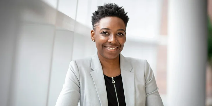 A financial manager wearing a gray suit.