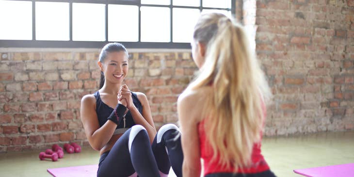 Fitness Instructor helping a client do sit-ups