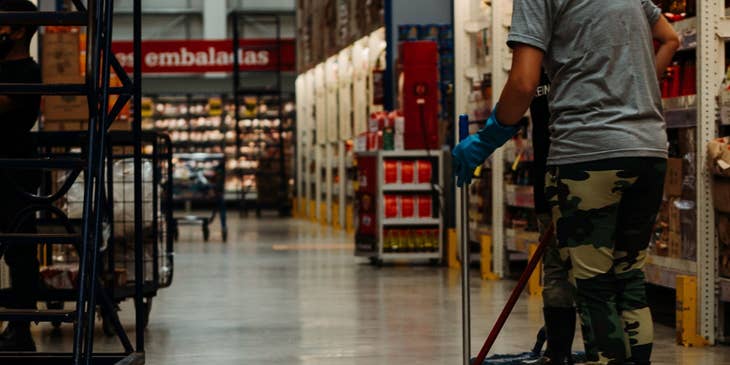 Floor tech cleaning a warehouse floor.