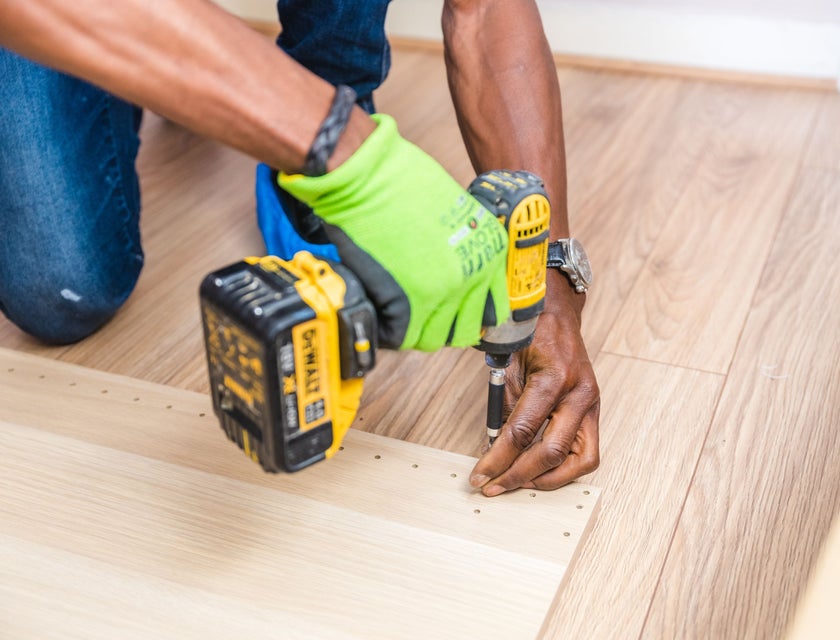Flooring Installer installing wooden floorboards