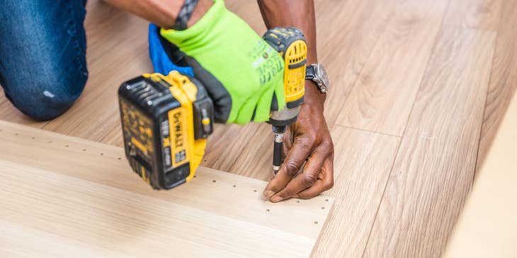 Flooring Installer installing wooden floorboards