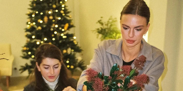 A floral designer working on a flower arrangement.