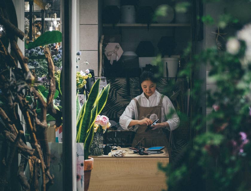 Florist cleaning her equipment in a flower shop