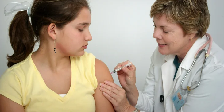 A flu shot nurse administering a vaccination.