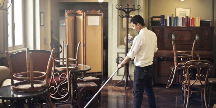 Food server mopping the floor after closing.