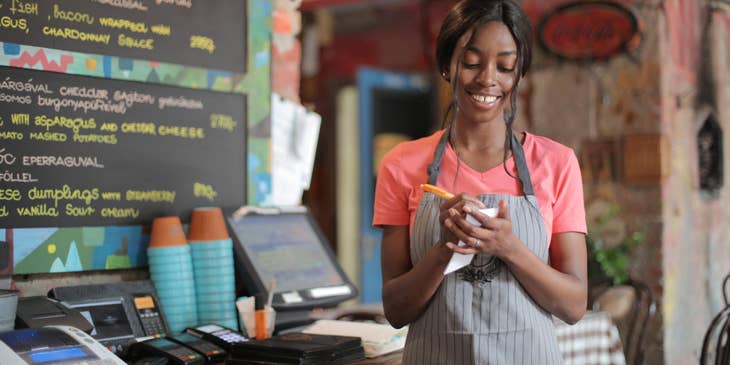 Food server ensuring accuracy of order before entering it into the system.