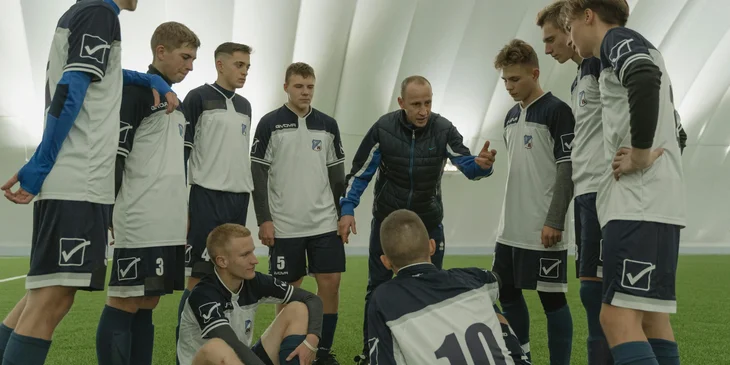 A coach talking to his football team.