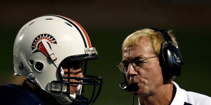 Coach talking to a football player