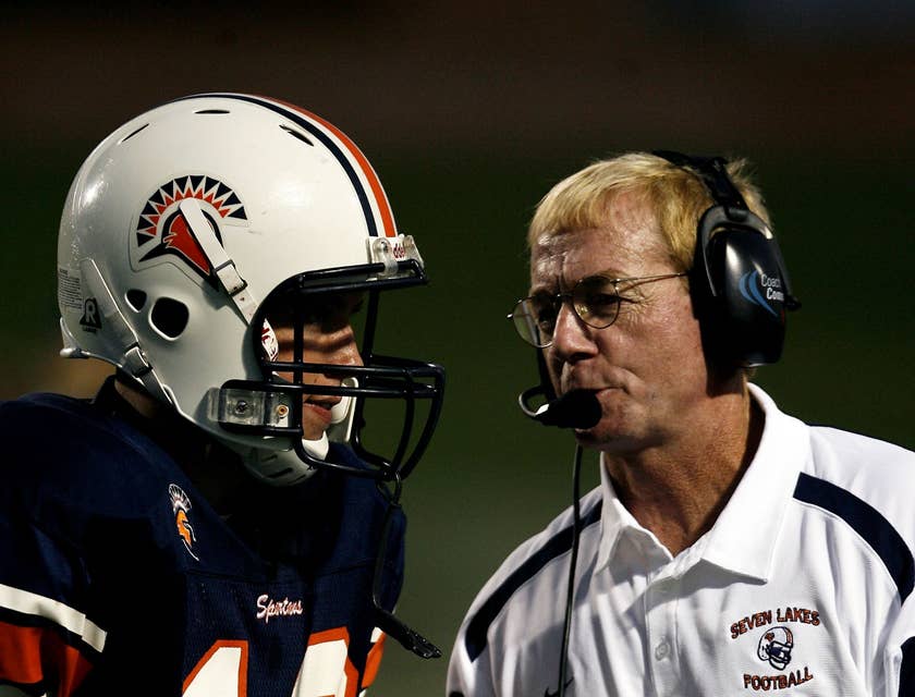 Coach talking to a football player