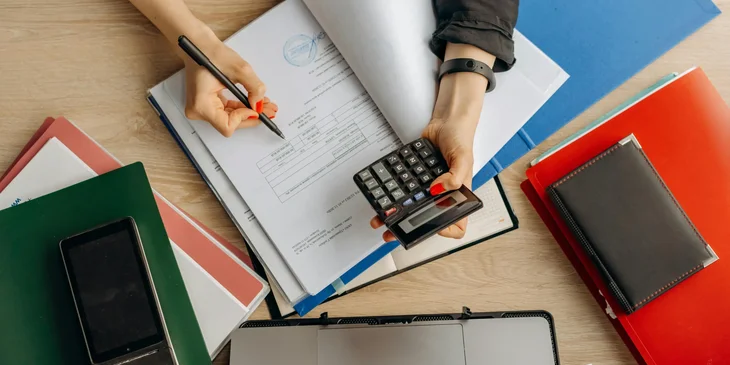 A forensic accountant examining financial documents.