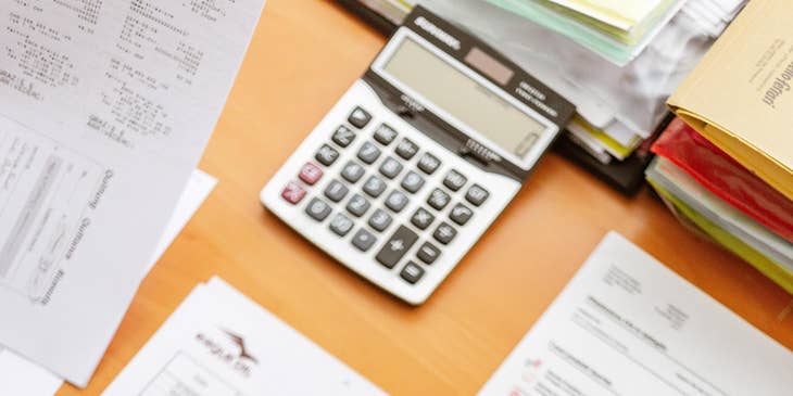 A Fraud Investigator working with a team member cross referencing documents to determine legitimacy of a fraud claim allegation.