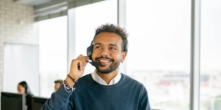 A freight broker talking to a client over the phone collaborating shipment schedule.