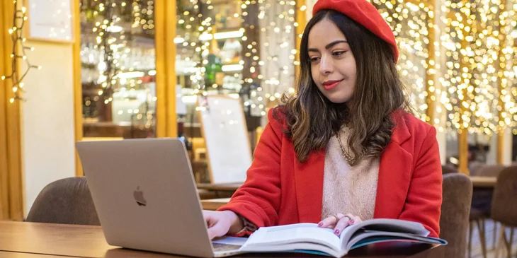 A french teacher sitting in a cafe doing an online class.