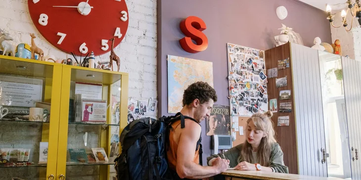 A front desk agent assisting a tourist.