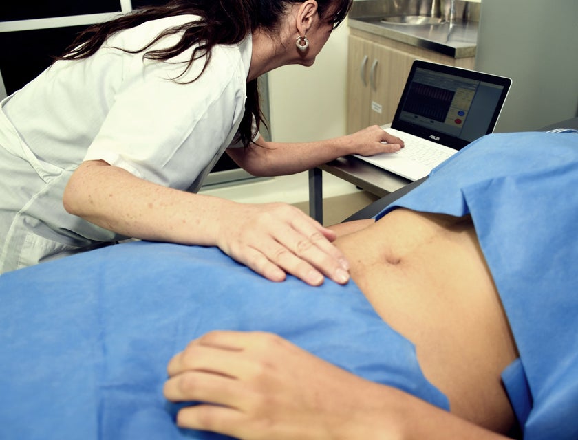 Gastroenterologist performing an abdominal check-up on the patient.