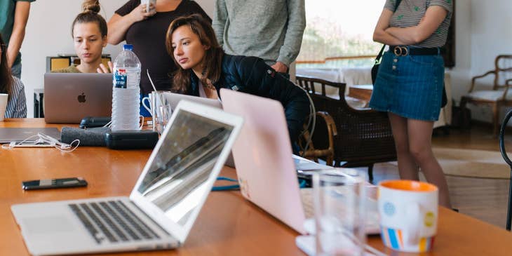 Group of young Gen Z people watching a laptop