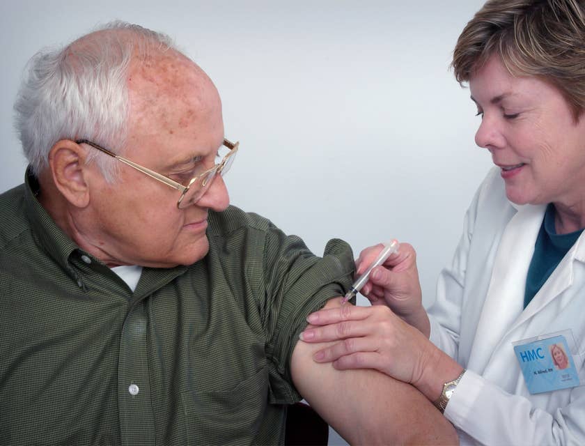 Geriatrician administers vaccine to the elderly.