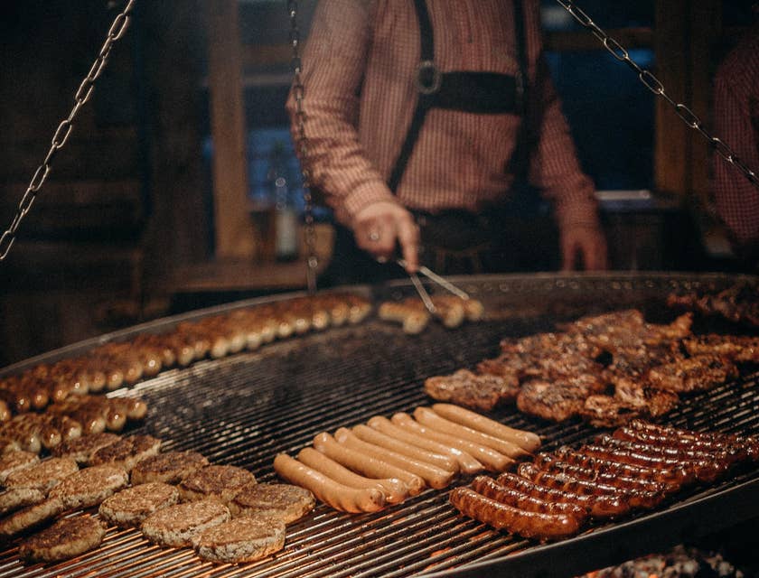 Grill Cook grilling patties and sausages.