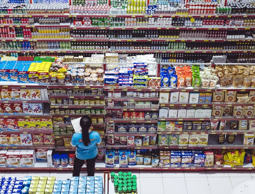 Grocery Clerk checking for products that needs to be replaced.