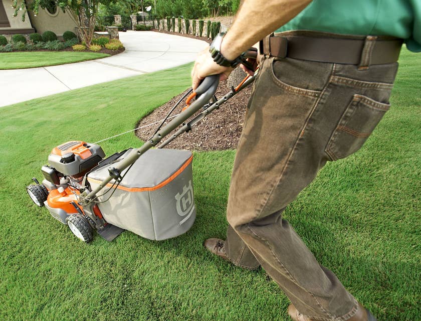 Groundsman mowing grass