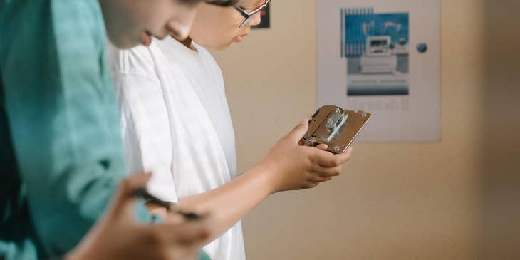 Hardware design engineer holding a part of a processor for inspection