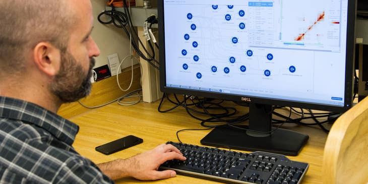 Health Information Technology professional sorting data from a medical program being used in the facility