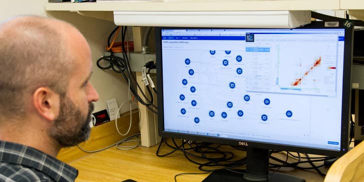 Health Information Technology professional sorting data from a medical program being used in the facility