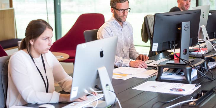 a team of Help Desk Technicians providing technical assistance to clients remotely