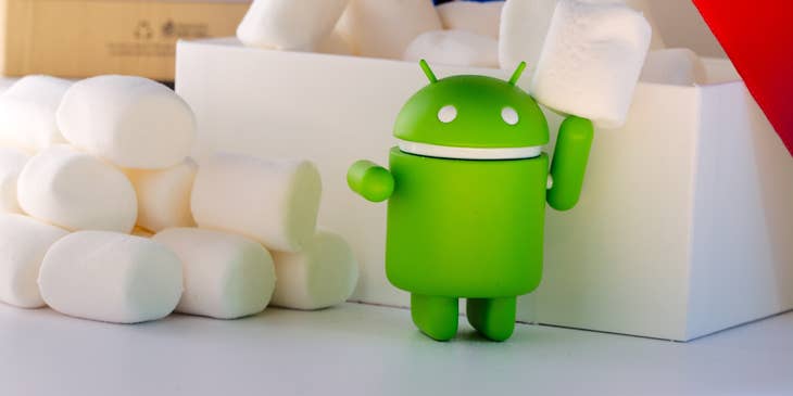 An Android figurine surrounded by marshmallows.