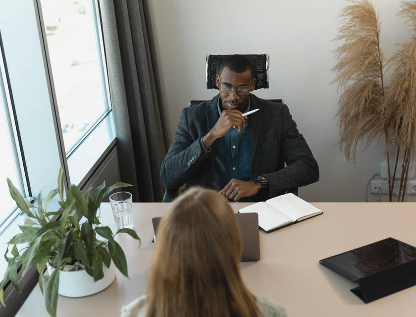A Hiring Manager in an office setting interviewing a female applicant.