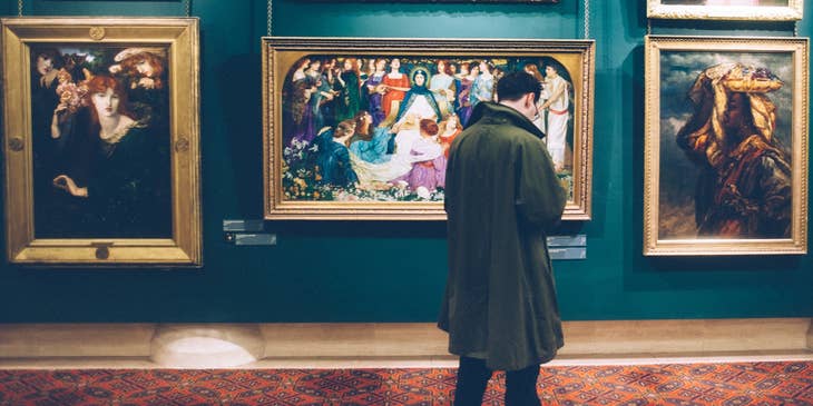 History Teacher looks at painting as he prepares a new lesson plan about art history