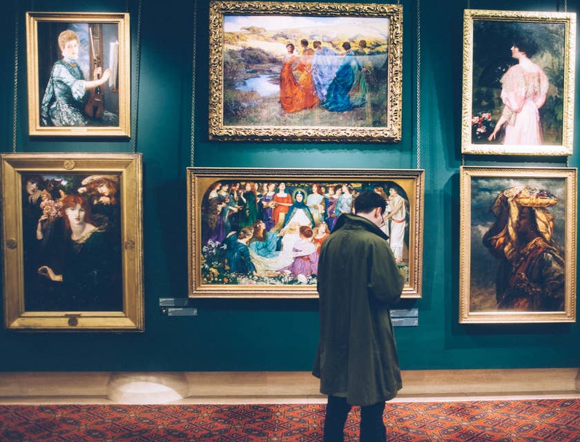 History Teacher looks at painting as he prepares a new lesson plan about art history