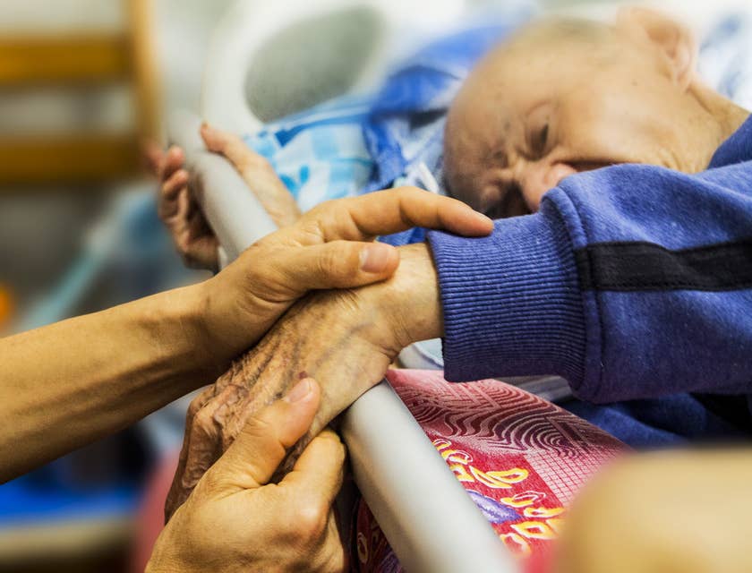 Home Care Nurse testing for muscle weakness.