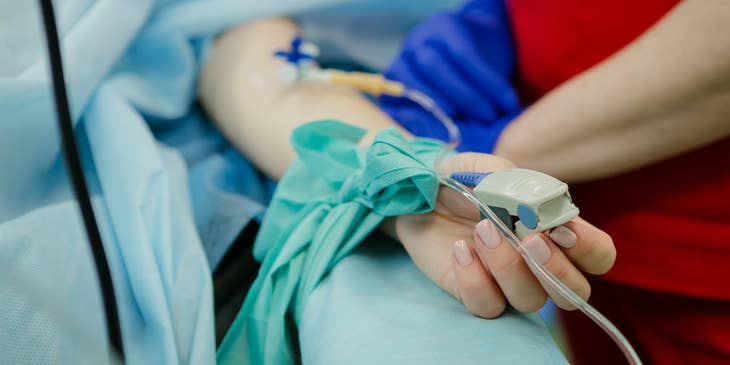 Hospital sitter monitoring patients' vital signs.
