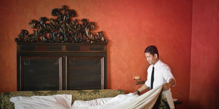 A Housekeeper fixing the sheets.