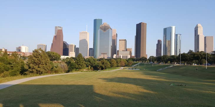 Houston downtown skyline with grassy area in foreground.