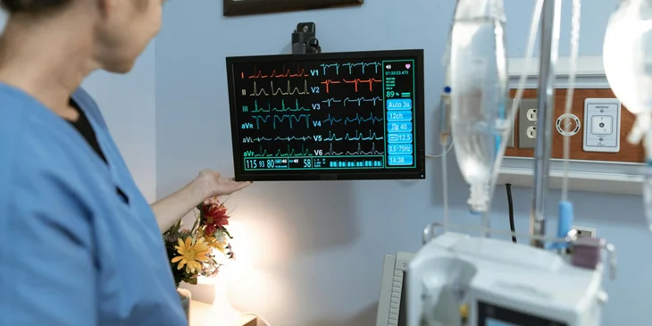 A licensed practical nurse checking a patients' vital signs.