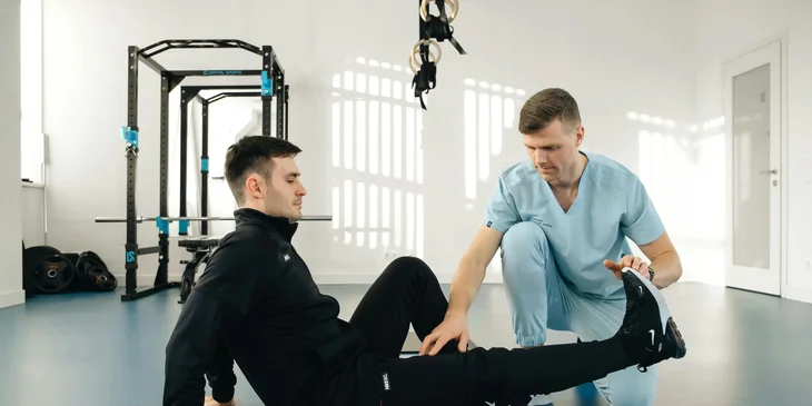 A physical therapy aide and a client doing a routine exercise.