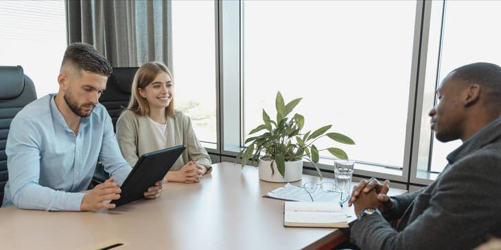 A man and woman interviewing a potential employee.